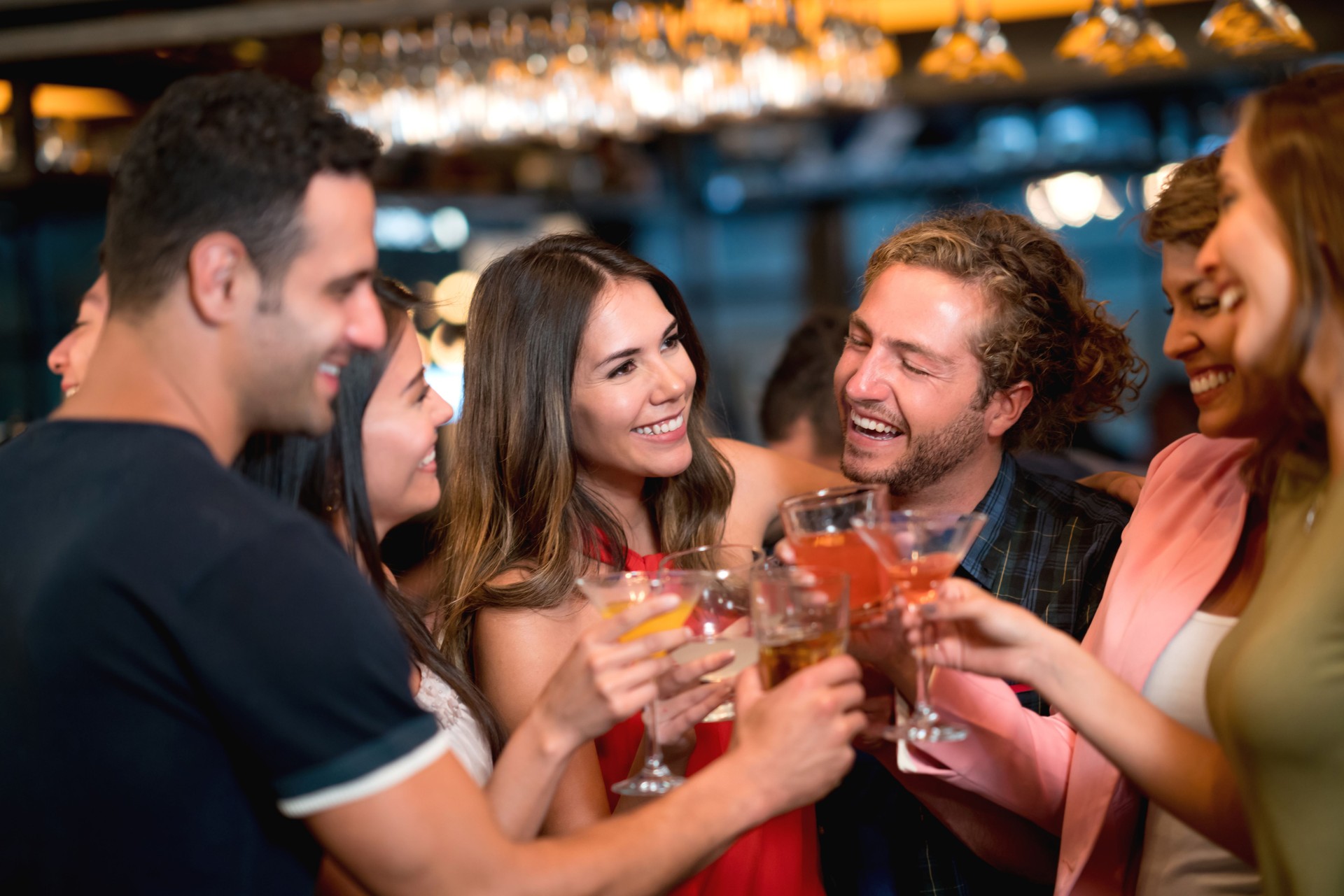 Group of friends at a bar making a toast